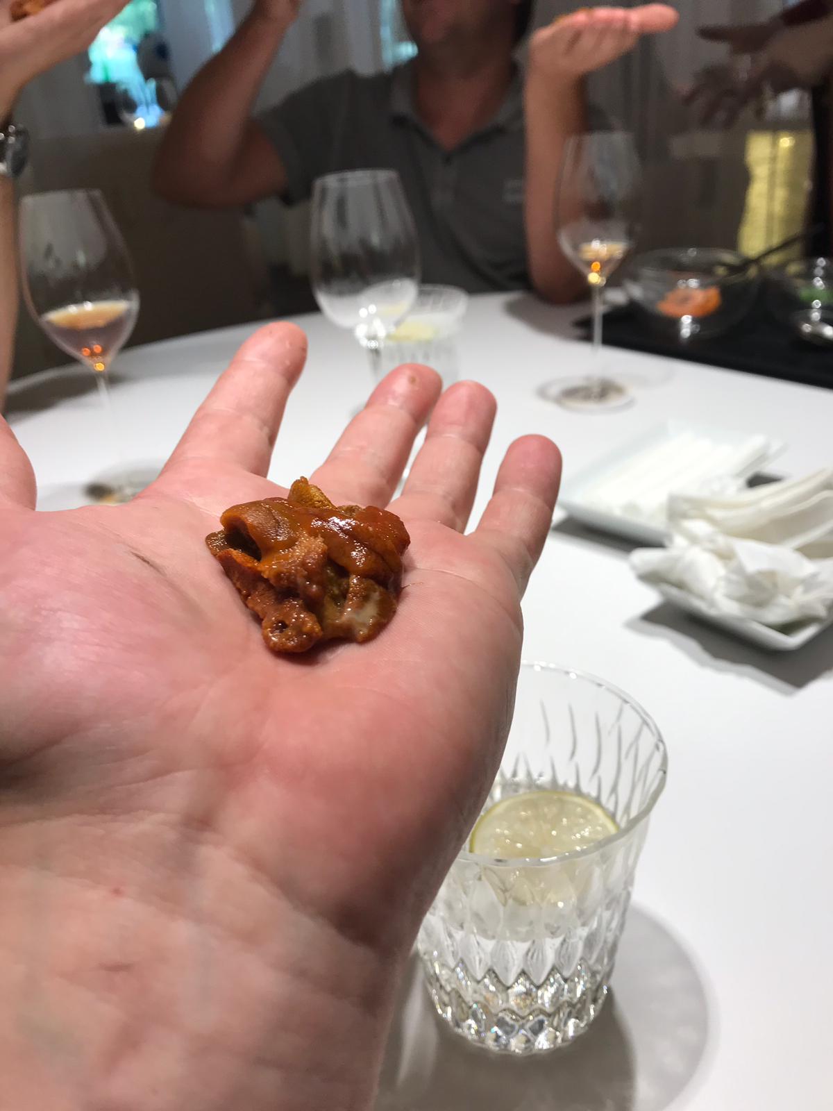 A course served on a hand at DiverXO